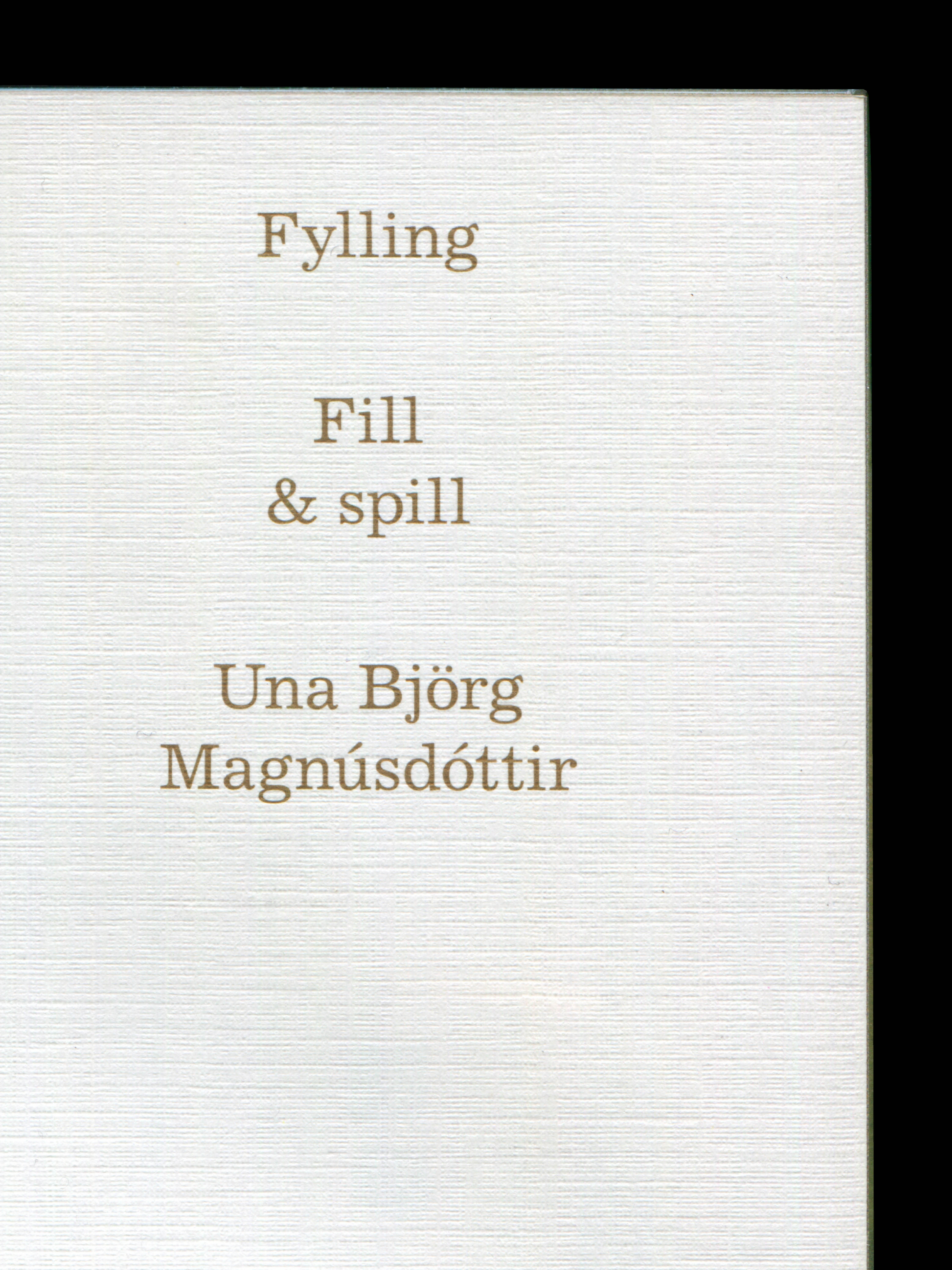 Close-up of a title page in a book. The paper has a linen texture. The title is centered and printed in gold.
